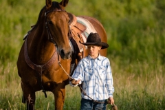 A cowboy and his horse.